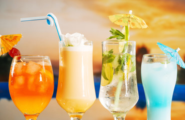 Orange soft yellow drinks with strawberry sliced lime mint in glasses