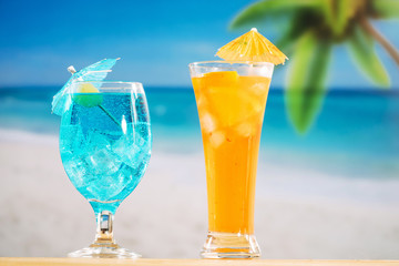 Glasses of fresh blue orange drink decorated with olive and umbrella