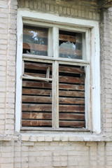 smashed a shot of an old brick building planked window at the Donbass in Ukraine
