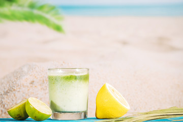 Glass of fresh whipped smoothie and sliced citrus
