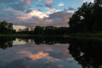 A colorful sunset with reflections at the cycling path through the water in Bokrijk in Belgium