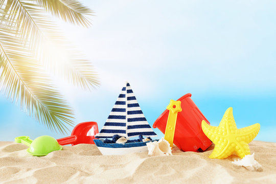 holidays. vacation and summer image with beach colorful toys for kid over the sand