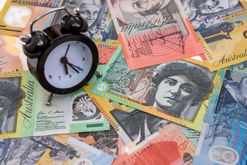 Clock with alarm at australian dollars close up