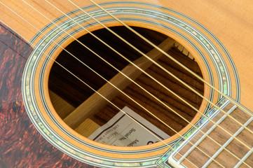 Obraz premium Acoustic Guitar detail - sound hole - above