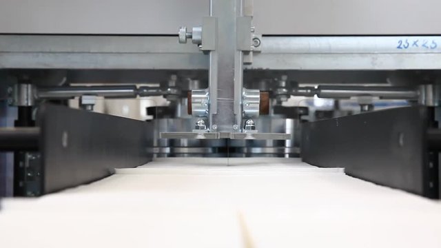 Production of white napkins in factory, close up