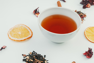  layout made of cup of black tea and leaves on a white background. Top view