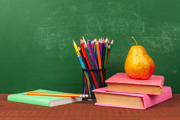 Back to School Concept with Stationery Supplies and Blackboard