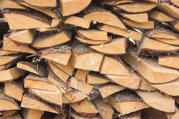 Wood for the village stove or fireplace stacked in a stack. Dry wood texture. Ecologically clean fuel. Selective focus.