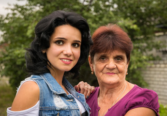 Naklejka premium Grandmother and beautiful young granddaughter. Life in Eastern Europe