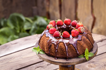 chocolate cake with fresh strawberries and chocolate icing summer mood