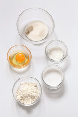 Different ingredients for cooking bakery foods, on white background.
