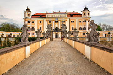 Fototapeta na wymiar MILOTICE, CZECH REPUBLIC - April 23rd, 2018: Entrance to the old castle with two rows of sculptures, historic background