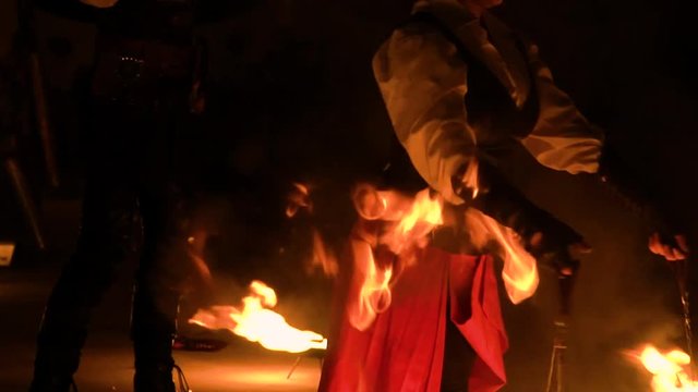 An amazing fire show at night. Two artist performing fire show