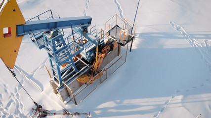 4K Aerial Shot Of A Pump Jack. oil production in the northern region. The equipment operates at the temperature of minus one.