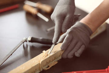 Female carpenter working in shop, closeup