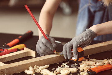 Female carpenter working in shop, closeup