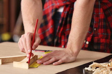 Obraz na płótnie Canvas Male carpenter working in shop, closeup