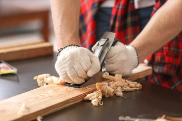 Male carpenter working in shop, closeup