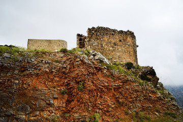 Foggy morning and the fortress in the mountains of Crete