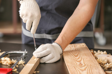 Male carpenter working in shop, closeup
