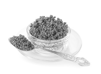 Bowl and spoon with delicious black caviar on white background
