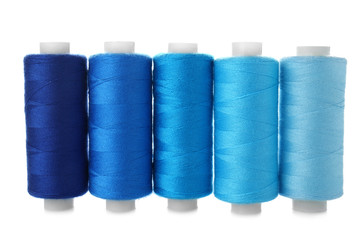 Colorful sewing threads on white background