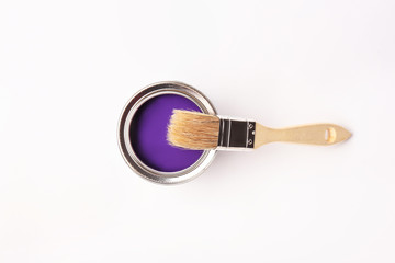 Can of paint and brush on white background