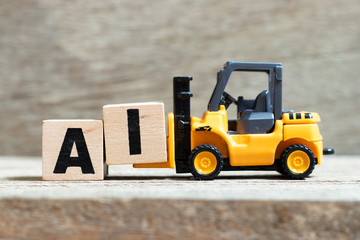 Toy forklift hold letter block i to complete word AI (Abbreviation of Page artificial intelligence)...