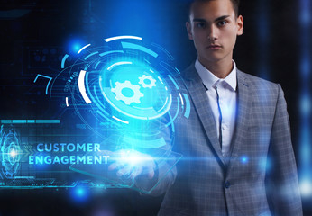 The concept of business, technology, the Internet and the network. A young entrepreneur working on a virtual screen of the future and sees the inscription: Customer engagement