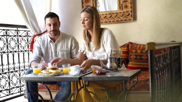 Couple having traditional breakfast in Moroccan riad
