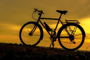 Fototapeta na wymiar Silhouette biker at sunset over the beach. Lifestyle Concept.