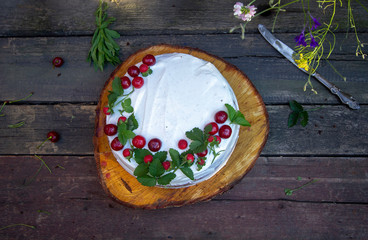 Fototapeta na wymiar summer sponge cake with sour cream and fresh berries