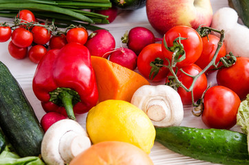 Eco-friendly fresh vegetables and fruits on a white wooden table.