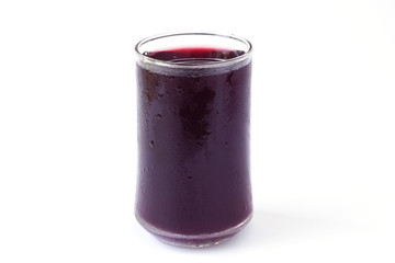 Red grape juice in glass isolated on white background