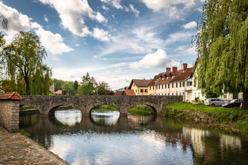 Obraz premium view on Ribnica old town with river Bistrica and medieval bridge, Slovenia