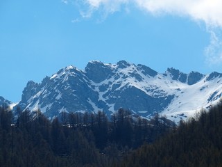 Obraz premium The mountains of the Italian Alps, in Val d'aosta, near the village of Chamois, Italy - June 2019.