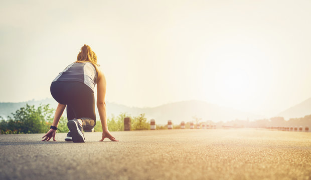 Woman Runner On The Road Shoes Are Prepared To Leave The Starting Point. Jogging Workout And Sport Healthy Lifestyle Concept