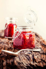 Homemade jam with raspberry on the wooden table, selective focus