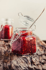 Homemade jam with raspberry on the wooden table, selective focus