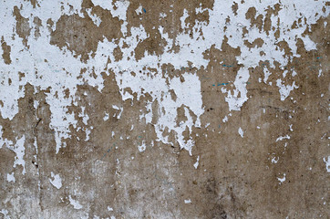Old and peeled of white painting cracked on the brown color cement. wall surface for art background and textured photo.
