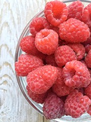 raspberries on wooden background