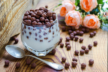 chocolate multislake balls with milk in a glass. delicious sweet breakfast