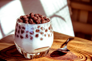 chocolate multislake balls with milk in a glass. delicious sweet breakfast