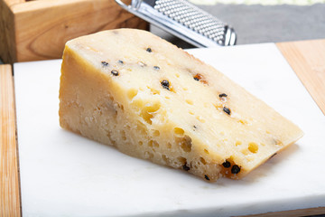 Italian aged pecorino cheese with black peppers made in region Nebrodi, Sicily, Italy