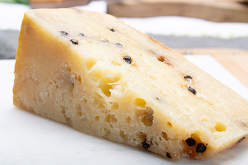 Italian aged pecorino cheese with black peppers made in region Nebrodi, Sicily, Italy