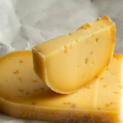 Piece of cow cheese with fenugreek seeds made in Belgian abbey by monks.