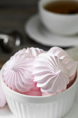 Pink meringue. French dessert. On the grey table