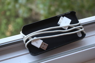 White wire coiled around the black cover.