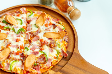 Pizza on round wooden tray