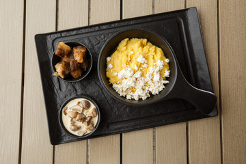 Typical Ukrainian dish polenta - Banosh with cheese and lard. Ukrainian cuisine. maize porridge...